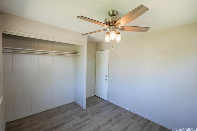 unfurnished bedroom with ceiling fan, hardwood / wood-style floors, and a closet