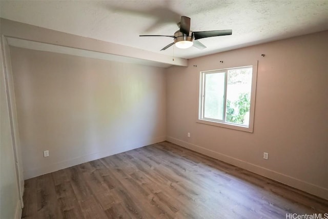 unfurnished room featuring hardwood / wood-style floors, a textured ceiling, and ceiling fan