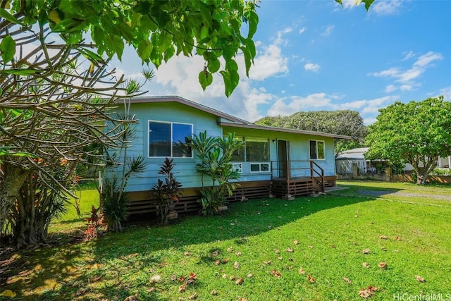 back of property featuring a yard