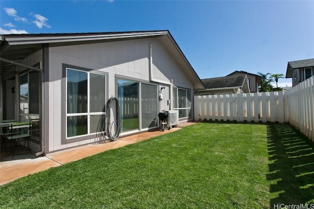 rear view of house with a yard