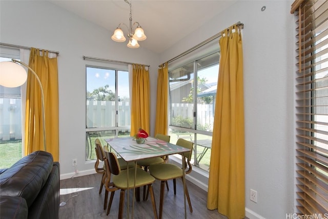 dining area featuring a chandelier, vaulted ceiling, and hardwood / wood-style floors