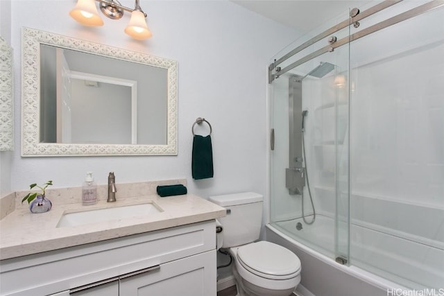 full bathroom with vanity, bath / shower combo with glass door, and toilet