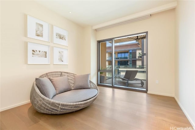 sitting room with hardwood / wood-style flooring