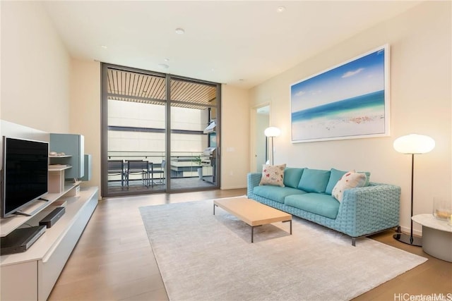 living room with expansive windows and hardwood / wood-style floors