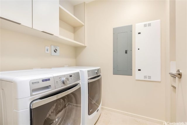 laundry room with washing machine and dryer, light tile patterned flooring, and electric panel