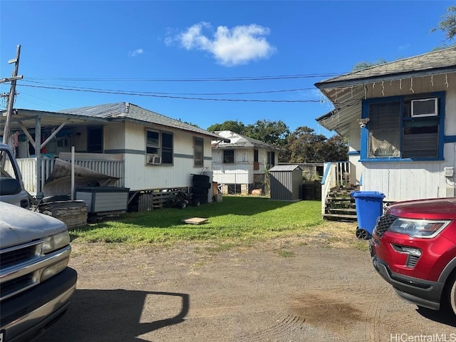 view of property exterior with a yard and cooling unit