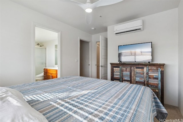 bedroom with ceiling fan, connected bathroom, carpet flooring, and a wall unit AC