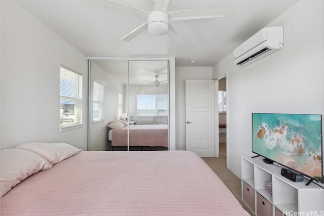 bedroom featuring light colored carpet, a wall unit AC, a closet, and ceiling fan