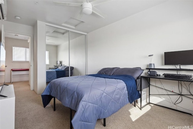 bedroom with ceiling fan, a closet, and light carpet