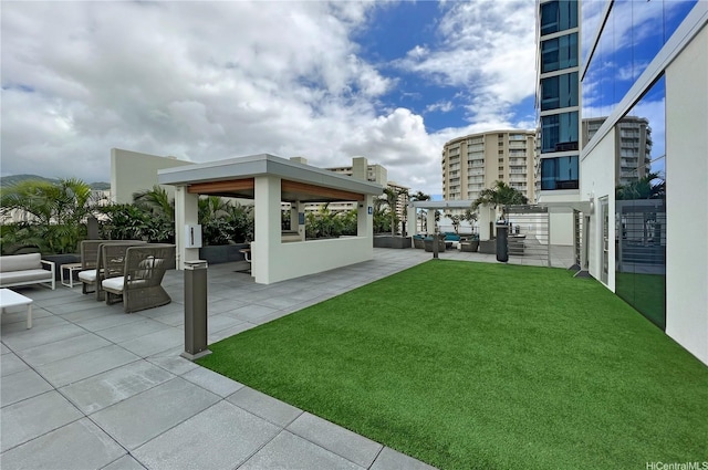 view of home's community with a gazebo, an outdoor hangout area, a lawn, and a patio