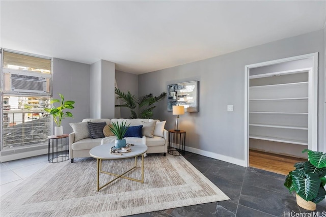 living room with cooling unit and dark tile patterned flooring