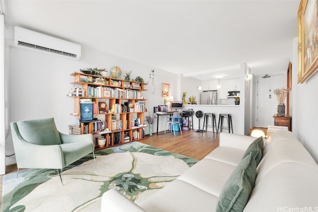 living room with hardwood / wood-style flooring and a wall mounted air conditioner