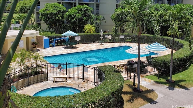 view of pool featuring a community hot tub and a patio area