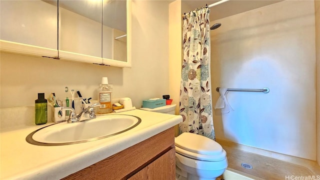 bathroom featuring vanity, toilet, and a shower with shower curtain