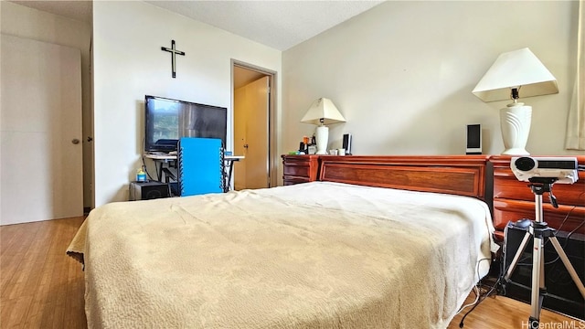 bedroom with hardwood / wood-style flooring