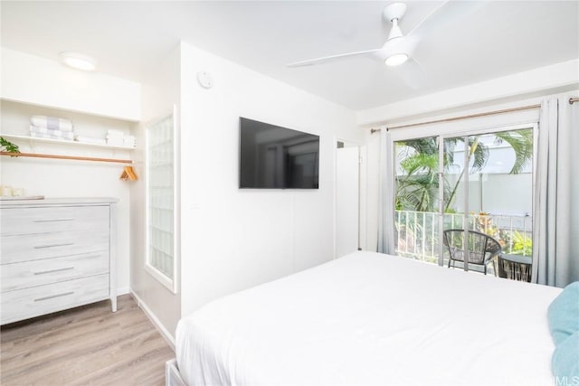 bedroom featuring access to exterior, light hardwood / wood-style floors, and ceiling fan