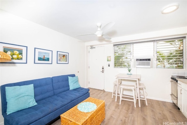 living room with cooling unit, ceiling fan, and light wood-type flooring