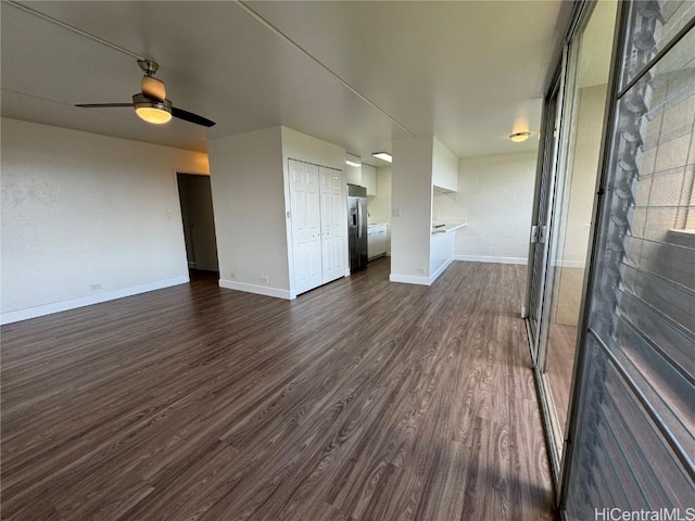 unfurnished living room with dark hardwood / wood-style floors and ceiling fan