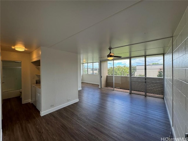 unfurnished living room with a healthy amount of sunlight, dark wood-type flooring, and ceiling fan