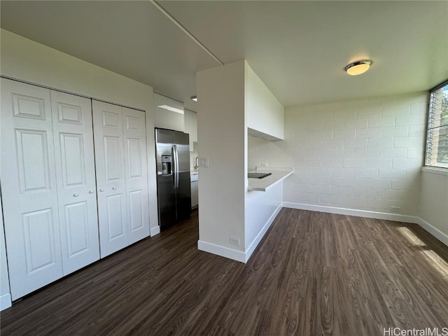 kitchen featuring white cabinetry, stainless steel fridge, and dark hardwood / wood-style flooring