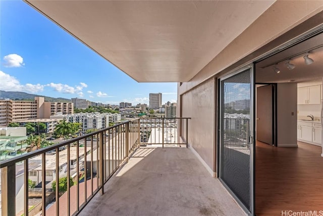 balcony featuring a sink and a city view