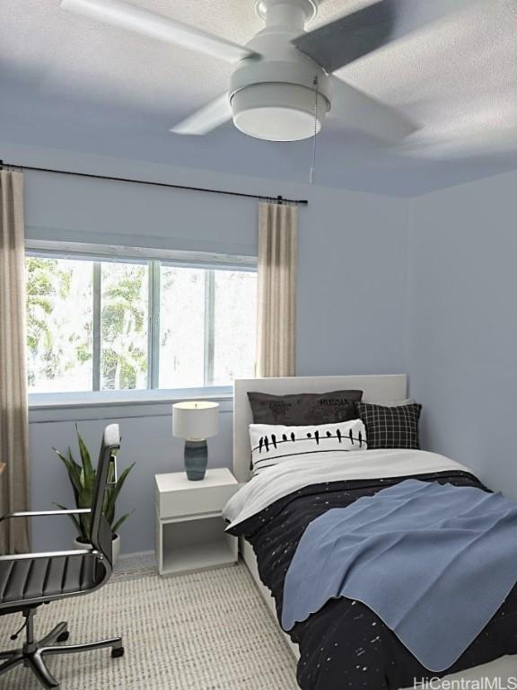 carpeted bedroom featuring ceiling fan and a textured ceiling