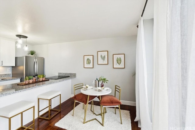 dining area with dark hardwood / wood-style floors