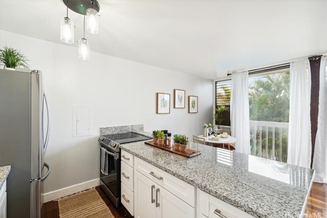 kitchen with stainless steel appliances, white cabinetry, hanging light fixtures, and light stone countertops