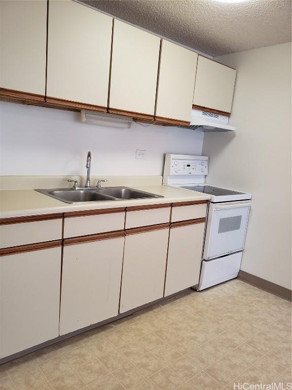 kitchen with electric stove, sink, a textured ceiling, and white cabinets