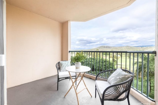 balcony featuring a mountain view