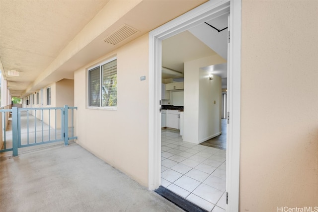 hall with light tile patterned floors