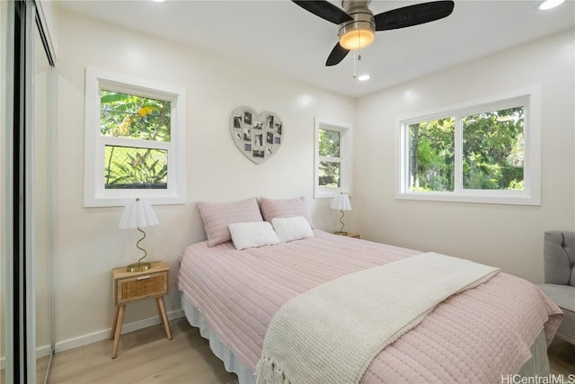 bedroom with ceiling fan, a closet, and light wood-type flooring