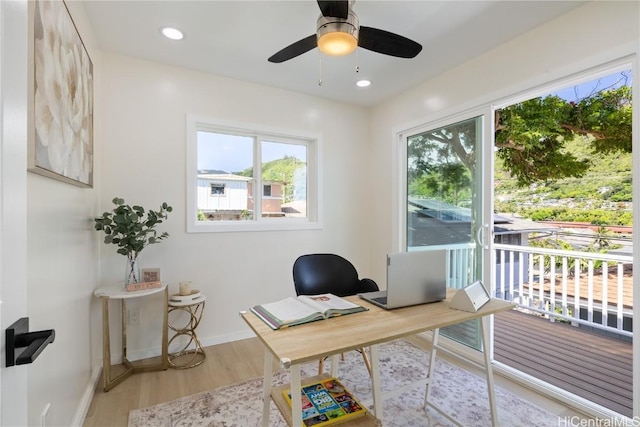 office space with ceiling fan and light hardwood / wood-style floors