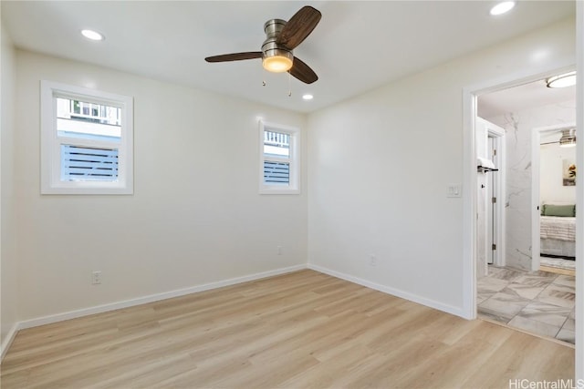 empty room featuring ceiling fan and light hardwood / wood-style flooring