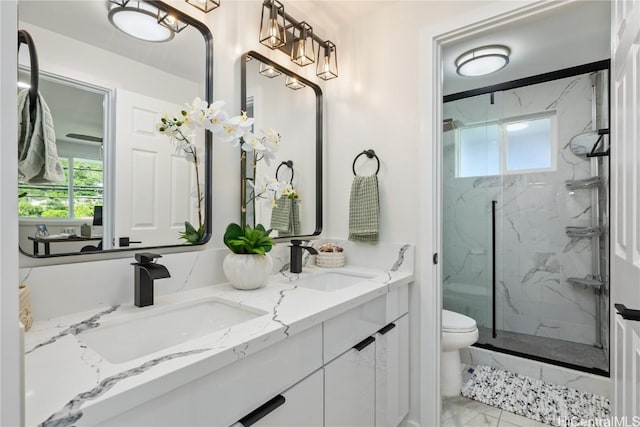 bathroom with walk in shower, vanity, and toilet