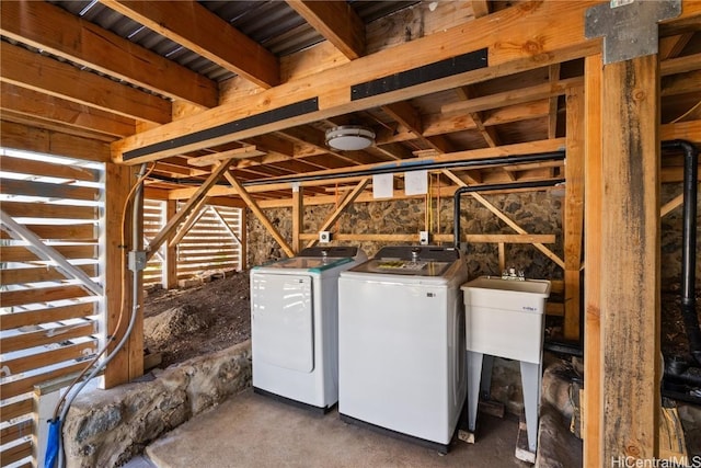 laundry area with washing machine and clothes dryer and sink