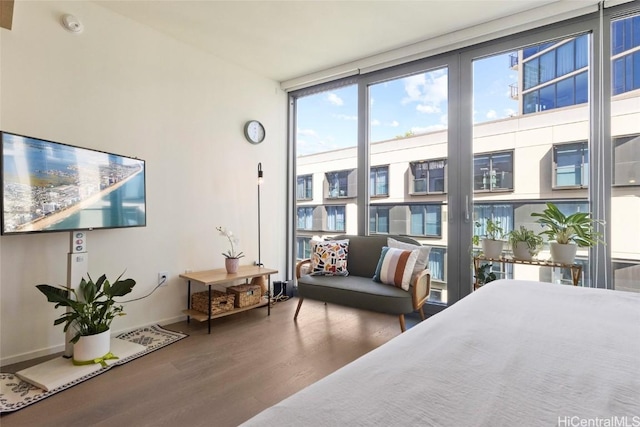 bedroom featuring hardwood / wood-style flooring and floor to ceiling windows