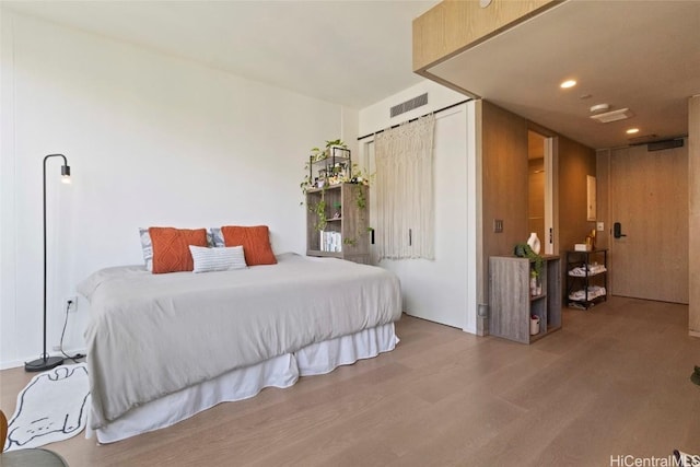 bedroom with hardwood / wood-style floors