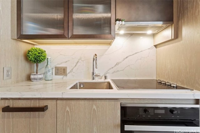 kitchen with extractor fan, tasteful backsplash, sink, black appliances, and light stone countertops