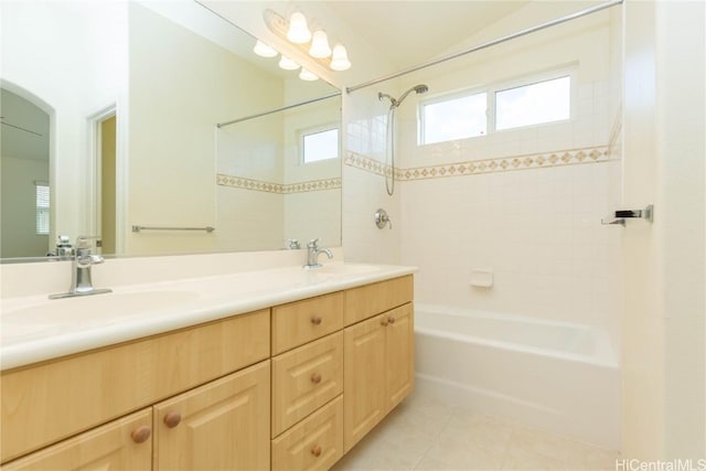 bathroom featuring a sink, double vanity, washtub / shower combination, and tile patterned flooring