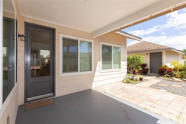 exterior space with a patio and roof with shingles