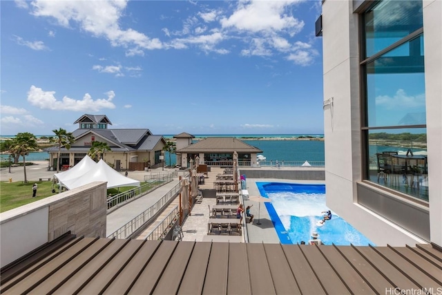 view of swimming pool featuring a water view