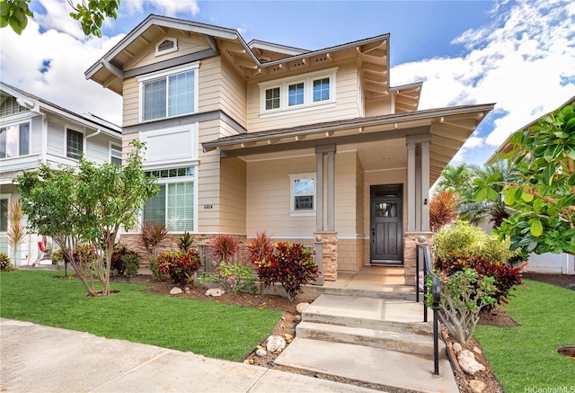 91-1137 Kai Kukuma St, Ewa Beach, HI 96706 - view of front facade with a front yard, covered porch, and stone siding