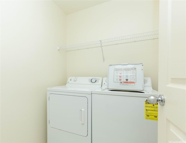 clothes washing area with independent washer and dryer and laundry area