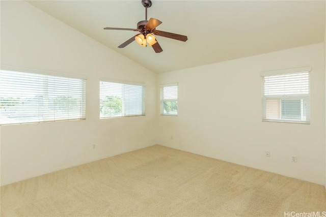 carpeted spare room featuring a ceiling fan and vaulted ceiling