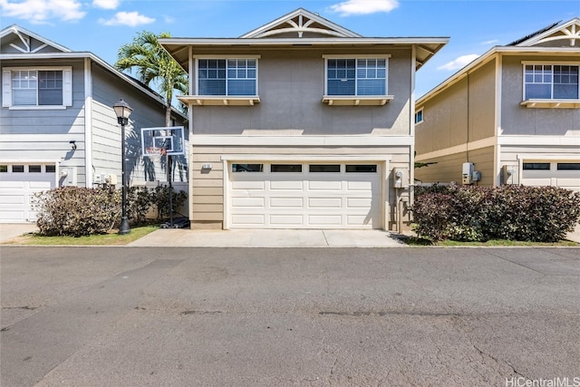 traditional home featuring aphalt driveway and an attached garage