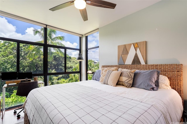 bedroom featuring a wall of windows and a ceiling fan