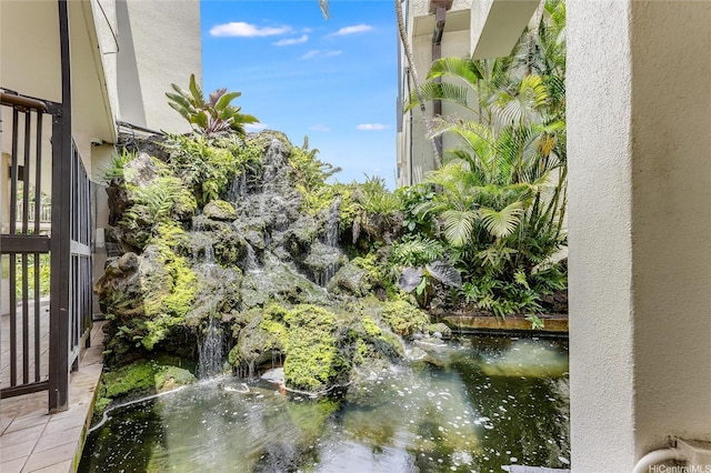 exterior space with a garden pond