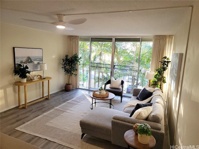 living room with hardwood / wood-style flooring, floor to ceiling windows, and ceiling fan