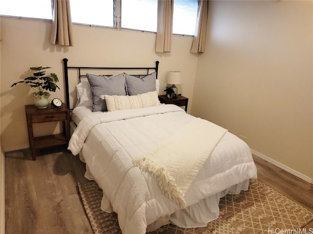 bedroom with hardwood / wood-style flooring